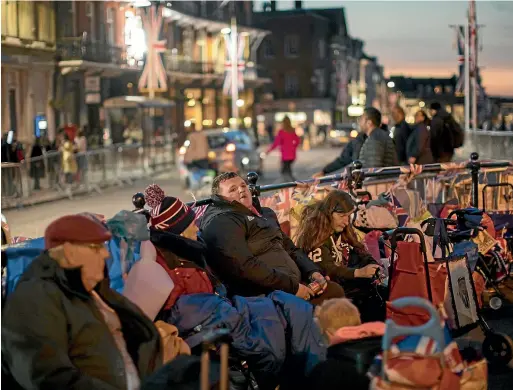  ?? AP ?? People spend the night outside Windsor Castle on Thursday. Preparatio­ns continue in Windsor ahead of the royal wedding of Britain’s Prince Harry and Meghan Markle today.