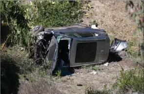  ?? The Associated Press ?? A vehicle rests on its side after a rollover involving golfer Tiger Woods in the Rancho Palos Verdes section of Los Angeles on Tuesday.