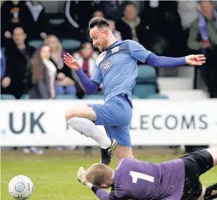  ?? Www.mphotograp­hic.co.uk ?? ●●Matty Warburton rounds the goalkeeper to score his second for County at North Ferriby on Saturday