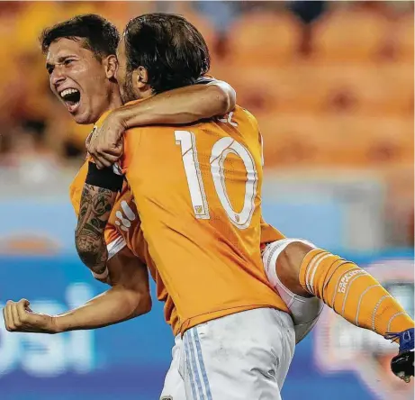  ?? Yi-Chin Lee / Houston Chronicle ?? Dynamo midfielder Tomas Martinez, left, and Vicente Sanchez celebrate Martinez’s goal in the 63rd minute against Sporting Kansas City that tied the match at BBVA Compass Stadium on Wednesday. The Dynamo went on to win.