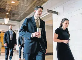  ?? [ANDREW HARNIK/AP PHOTO] ?? House Speaker Paul Ryan of Wis., center, accompanie­d by his Press Secretary AshLee Strong, right, walks to the Capitol Building from the Capitol Visitor’s Center, Thursday in Washington.