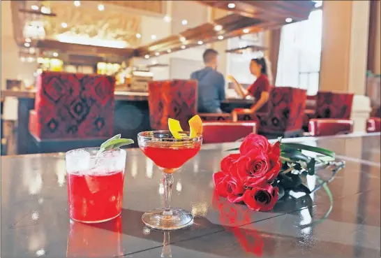  ?? [ERIC ALBRECHT/DISPATCH] ?? For Valentine’s Day, treat your sweetie to a Darkwing Duck cocktail, left, or an Open Season 0.1 cocktail, made at The Citizens Trust.