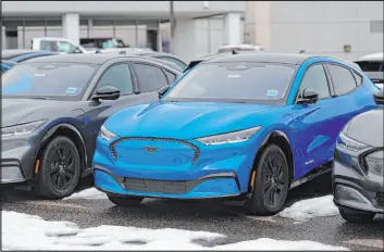  ?? David Zalubowski The Associated Press ?? 2024 Mustang Mach-e electric vehicles are displayed at a Ford dealership Sunday in Broomfield, Colo. Epa-proposed regulation­s would require up to two out of every three vehicles sold in the U.S. to be electric by 2032.