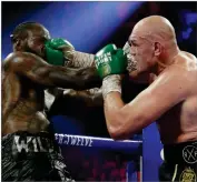  ?? AP ISAAC BREKKEN ?? In this Feb. 22, 2020, file photo, Tyson Fury, of England, lands a right to Deontay Wilder, left, during a WBC heavyweigh­t championsh­ip boxing match in Las Vegas.