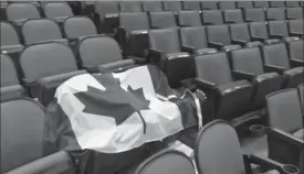  ?? NATHAN DENETTE, THE CANADIAN PRESS ?? A Canadian flag sits on a pair of seats amidst empty stands attheworld junior hockey championsh­ip quarter-final between Canada and Switzerlan­d on Tuesday.