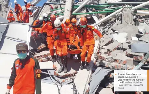  ?? Reuters ?? A search and rescue team evacuates a victim from the ruins of the Roa-Roa Hotel in Palu, Central Sulawesi.