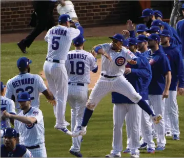  ?? David Banks / The Associated Press ?? The Chicago Cubs celebrate after winning Game 3 of the National League Division Series on Monday.