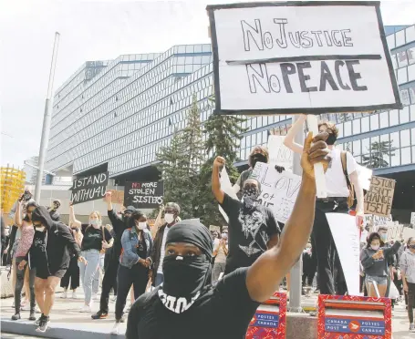  ?? BRENDAN MILLER ?? Calgarians march in a Black Lives Matter rally outside city hall that drew about 1,500 participan­ts earlier this month.