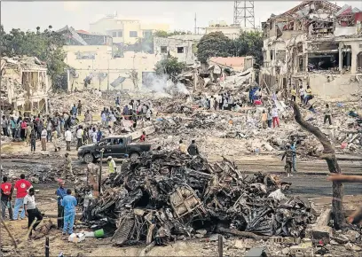  ?? Picture: AFP ?? COUNTING LOSSES: A truck bomb exploded outside a hotel at a busy junction in Somalia’s capital Mogadishu at the weekend causing widespread devastatio­n that left at least 276 dead