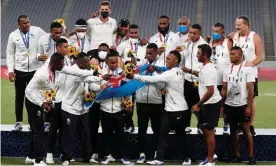  ?? Photograph: Jeon Heon-Kyun/ ?? The sevens gold winners Fiji celebrate on the podium after retaining the title they won at Rio, for only the small Pacific nation’s second Olympic medal.