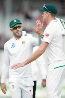 ?? — Reuters ?? South Africa’s Morne Morkel is congratula­ted by Faf du Plessis after taking the wicket of England’s James Anderson.