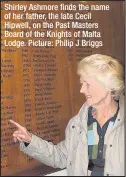  ??  ?? Shirley Ashmore finds the name of her father, the late Cecil Hipwell, on the Past Masters Board of the Knights of Malta Lodge. Picture: Philip J Briggs