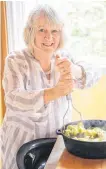  ?? JACKSON MACLEAN PHOTO ?? Marian Francis White mashes the ingredient­s for leek and potato soup, one of more than 100 plant-based recipes in her cookbook "Island Vegan," published by Breakwater Books.