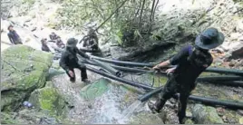  ?? AP ?? Thai soldiers divert water from the cave where 12 boys and their coach have been trapped.