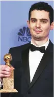  ??  ?? Damien Chazelle poses in the press room with the award for best screenplay - motion picture for "La La Land".