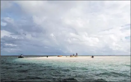  ?? Magenta Hyde ?? Guests at Mandala Island Resort visit the nearby cay, which appears only at low tide.