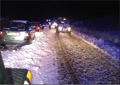  ??  ?? Stranded: Cars stuck in snow drifts on the A68 at Carter Bar