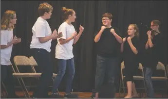  ??  ?? Above: Children from the St. Paul Lutheran Youth perform a skit to a reading of the short story “What if the Zebras Lost Their Stripes?” by John Reitano at the Martin Luther King Jr. Celebratio­n of Unity at First United Methodist Church. Left:...