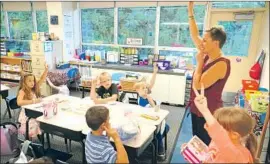  ?? Ben Garver Berkshire Eagle ?? “IT’S INCUMBENT” on adults to expose kids to diverse role models, a psychologi­st says. Above, Laura Groves and her first-grade class in Pitssfield, Mass.