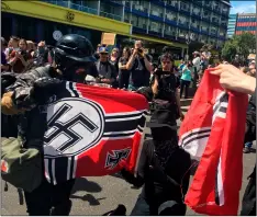  ??  ?? In this 2018 file photo, counter protesters tear a Nazi flag, in Portland, Ore. AP