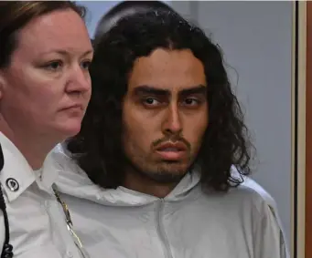  ?? CHRIS CHRISTO PHOTOS / HERALD STAFF ?? FACING MURDER CHARGES: Carlos Asencio enters the courtroom to be arraigned at Worcester District Court Friday. Below, a woman is held back at the arraignmen­t.