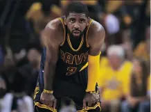  ?? EZRA SHAW/ GETTY IMAGES ?? Cavaliers’ Kyrie Irving takes a break during the NBA Finals Thursday night. Irving fractured his kneecap later in the game.