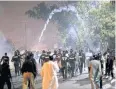  ??  ?? CAUSING A SCENE: Police fire tear-gas canisters to disperse supporters of Khadim Rizvi protesting his arrest on Friday.