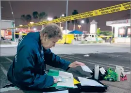  ?? Marcus Yam
Los Angeles Times ?? JOAN DAVIS, a longtime member of L.A.’s volunteer Crisis Response Team, sorts through paperwork at the scene of a fatal car accident in Wilmington.
