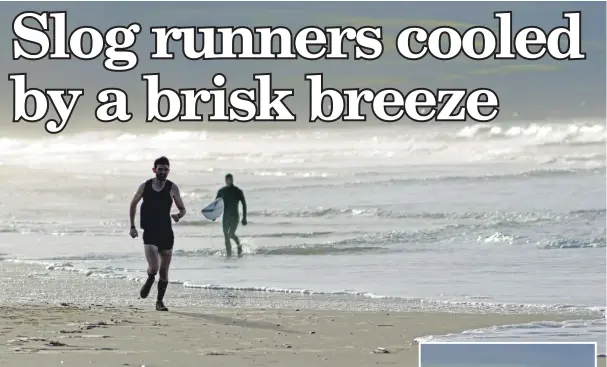  ??  ?? Overall winner Stuart McGeachy passes surfer Dougie Taylor on the expanse of Westport beach. 25_c52slog201­716