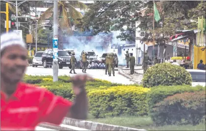  ?? Photo: Nampa/AFP ?? Poll standoff… A man runs for safety as Zanzibar riot police officers conduct an operation after the opposition called for protests in Stone Town.