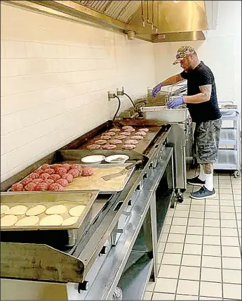  ?? Photo submitted ?? Chef Jeff Wetzel spends his Tuesday making 125 Bouvier burgers at St. Bernard Catholic Church. Wetzel is in the process of opening his own restaurant but, while he waits for renovation­s to be complete, he donates his time to the church project designed to give meals to homebound parishione­rs.