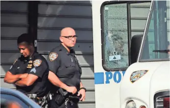  ?? SETH WENIG, AP ?? Officers stand near the vehicle, its window shattered, in which a fellow officer was fatally shot.