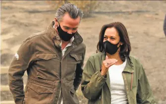  ?? Carlos Avila Gonzalez / The Chronicle ?? Gov. Gavin Newsom and Sen. Kamala Harris, the incoming Democratic vice president, review devastatio­n from the Creek Fire during a tour of Pineridge ( Fresno County) in September.