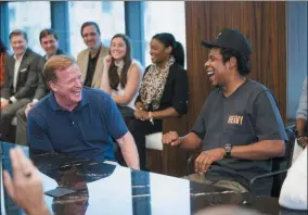  ?? BEN HIDER — THE ASSOCIATED PRESS ?? NFL Commission­er Roger Goodell, left, and Jay-Z appear at a news conference at ROC Nation on Aug. 14 in New York.