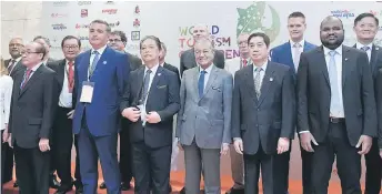 ?? — Bernama photo ?? Dr Mahathir (front, third right) poses for a group photo with speakers at the 2019 World Tourism Conference. Also seen is Mohamaddin (front, third left).