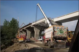  ?? The Associated Press ?? TRADE ROUTE: In this May 11, 2017, file photo, work in progress at a new internatio­nal trade route near Havalian in Pakistan. China’s plan for a modern Silk Road of railways, ports and other facilities linking Asia with Europe recently hit a $14...