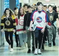  ?? GRAHAM HUGHES / THE CANADIAN PRESS ?? Students at John Rennie High School in Montreal wear jerseys Thursday in honour of the bus crash victims.