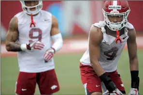  ?? NWA Democrat-Gazette/ANDY SHUPE ?? Arkansas cornerback Jarques McClellion (right) said, “We’re going to try to win the belt every day,” after the Razorbacks’ defense won the first awarding of the “championsh­ip belt” after Monday’s practice.