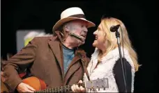  ?? PHOTO/TONY AVELAR ?? In this Oct. 24, 2010 file photo, Neil Young (left) and his wife Pegi Young perform during the Bridge School Benefit concert in Mountain View, Calif. AP