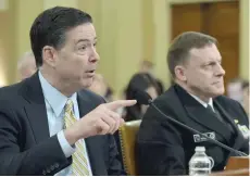  ?? — AFP ?? FBI Director James Comey gestures as National Security Agency Director Mike Rogers looks on during the House Permanent Select Committee on Intelligen­ce hearing on Russian actions during the election campaign in Washington.