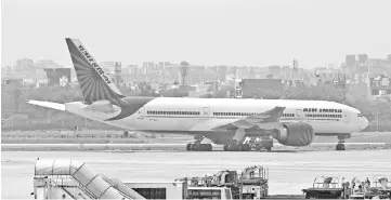  ?? — AFP photo ?? In this file photo an Air India plane is seen parked on the tarmac at the Indira Gandhi Internatio­nal Airport in New Delhi. The Indian government’s attempt to sell debt-laden national carrier Air India is in danger of hitting the skids as a key...