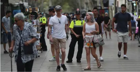  ??  ?? POLICE PATROL the area yesterday where a van crashed into pedestrian­s in Barcelona’s Las Ramblas last week.