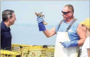  ?? Ned Gerard / Hearst Connecticu­t Media ?? Lobsterman Mike Kalaman speaks with state Sen. Bob Duff onboard the Dark Horse while he pulls up his lobster traps from the waters of Long Island Sound off the coast of Norwalk on Tuesday.