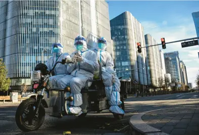  ?? NOEL CELIS/GETTY-AFP ?? People in personal protective gear Saturday on a street in Beijing. China’s “zero-COVID” policy appears to be failing.