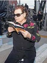  ??  ?? Country Music Hall of Famer Ronnie Milsap holds a book backstage at the free “Blake & Friends” concert Blake Shelton co-hosted Saturday in his adopted hometown of Tishomingo.