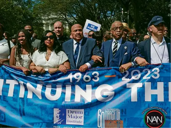  ?? JACQUELYN MARTIN/ASSOCIATED PRESS ?? The Rev. Al Sharpton (second from right) joined Martin Luther King III (third from left); King’s wife, Arndrea Waters King; and their, daughter Yolanda King, on Saturday as they marched in the same place that the historic 1963 gathering took place.