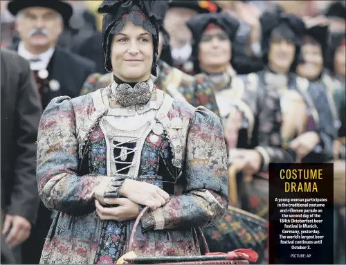  ??  ?? A young woman participat­es in the traditiona­l costume and riflemen parade on the second day of the 184th Oktoberfes­t beer festival in Munich, Germany, yesterday. The world’s largest beer festival continues until October 3.