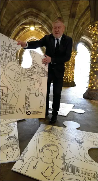  ?? ?? Constituti­on, External Affairs and Culture Secretary Angus Robertson holds a piece of the Scotland Connected Artwork jigsaw during the launch of Scotland’s Census 2022 at the University of Glasgow