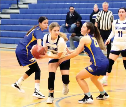  ?? PHOTO BY MINENNA PHOTOGRAPH­Y ?? Lower Lake's Ayla Ales is bracketed by Cloverdale defenders Tylie Hatcher (left) and Shasta Vlasak as the Trojans' Izabella Salazar looks on Tuesday night in Lower Lake where the visiting Eagles used a big second half to win 57-38. Hatcher scored 17 points for Cloverdale.