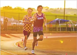  ?? Steven Eckhoff ?? Darlington’s Brock Ferguson (right) battles for position in the 3,200-meter run as the sun sets Thursday in the Class A Division I state championsh­ips at Barron Stadium.